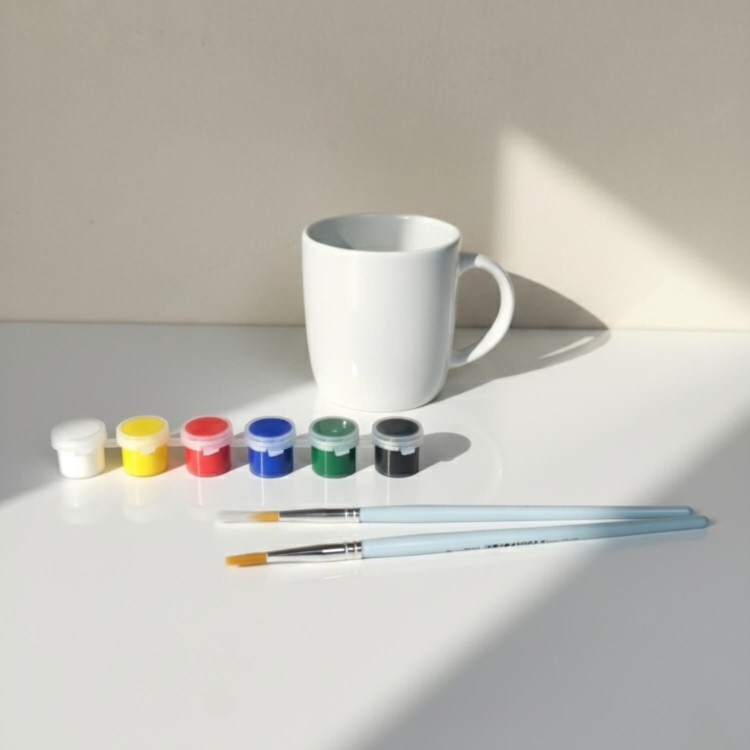 Zawartość zestawu kreatywnego DIY – biały kubek Baza, farby i pędzle.